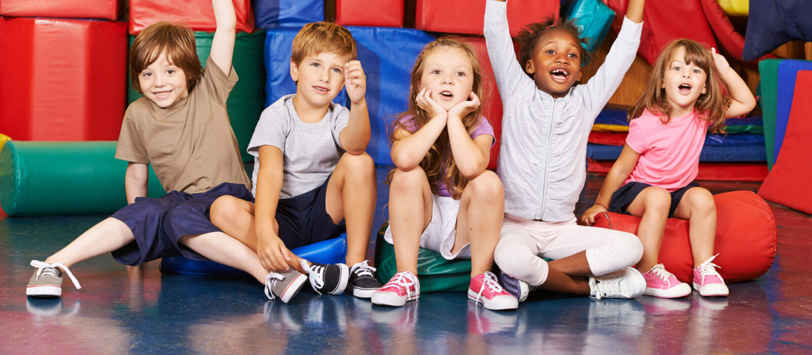 Children cheering in gym of school - Leap into Learning Preschool